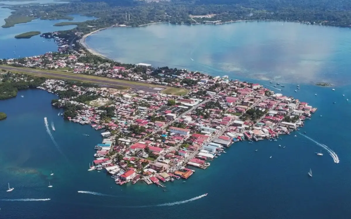 Aerial view of Bocas Town with the airstrip cutting through the island and boats in the harbor
